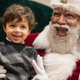 A child seated on the lap of the black Santa at the Mall of America
Twitter